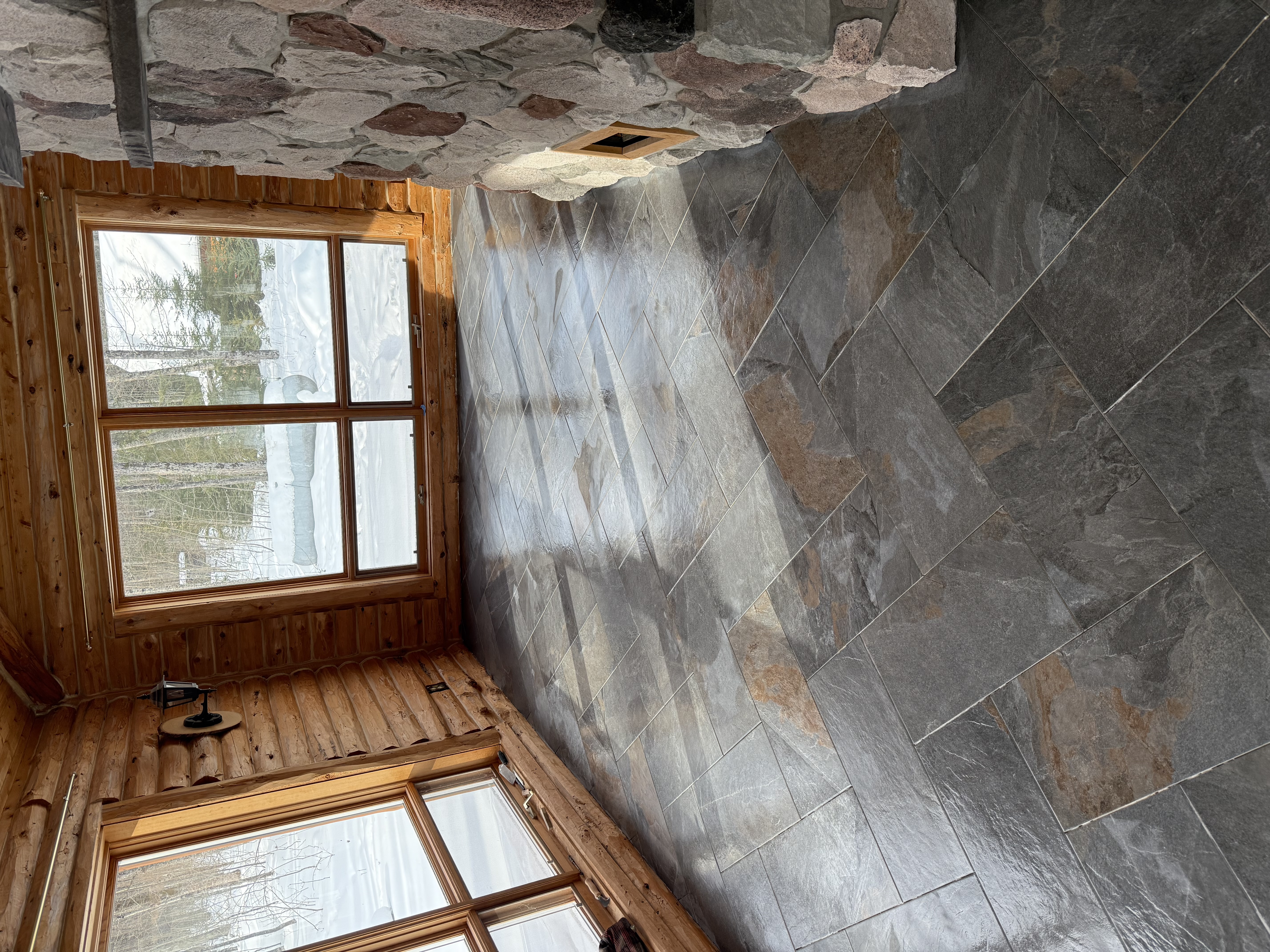 Custom slate tile floor in log cabin by DTR Construction